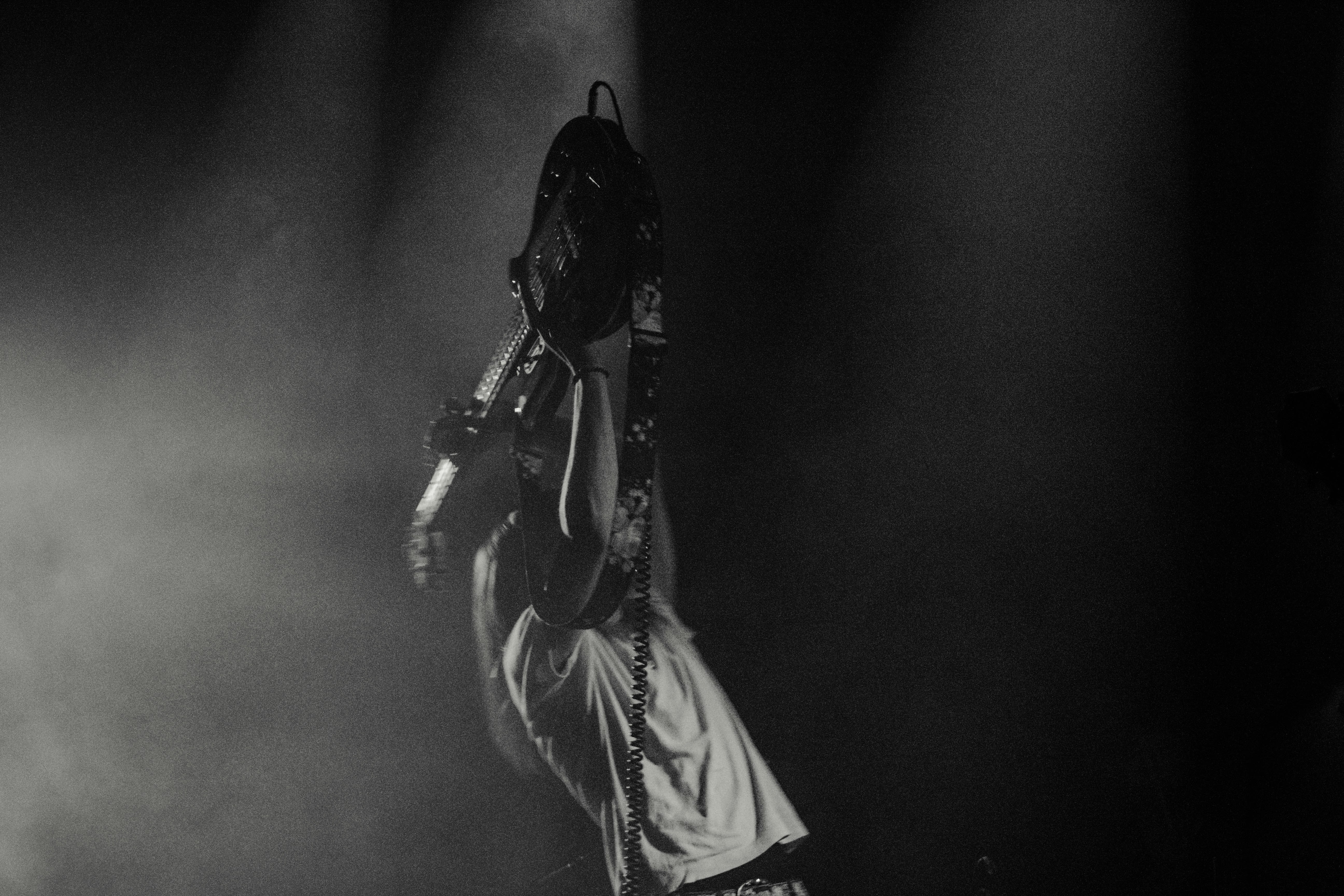 man lifting his electric guitar